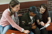Three female students looking at a sheet of paper