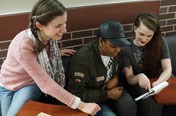 Three female students looking at a sheet of paper