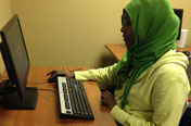 woman with head scarf operating computer