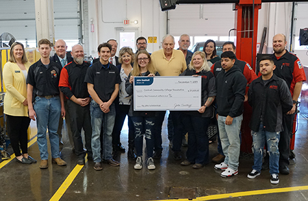 People gathered around a large check.
