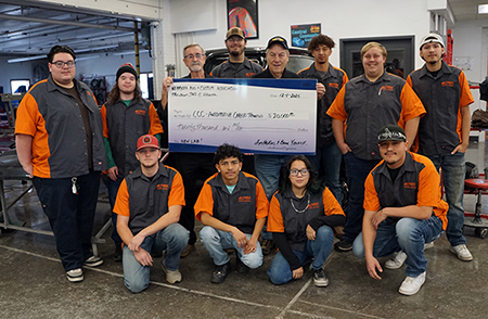 NRCA representatives and students pose with check.